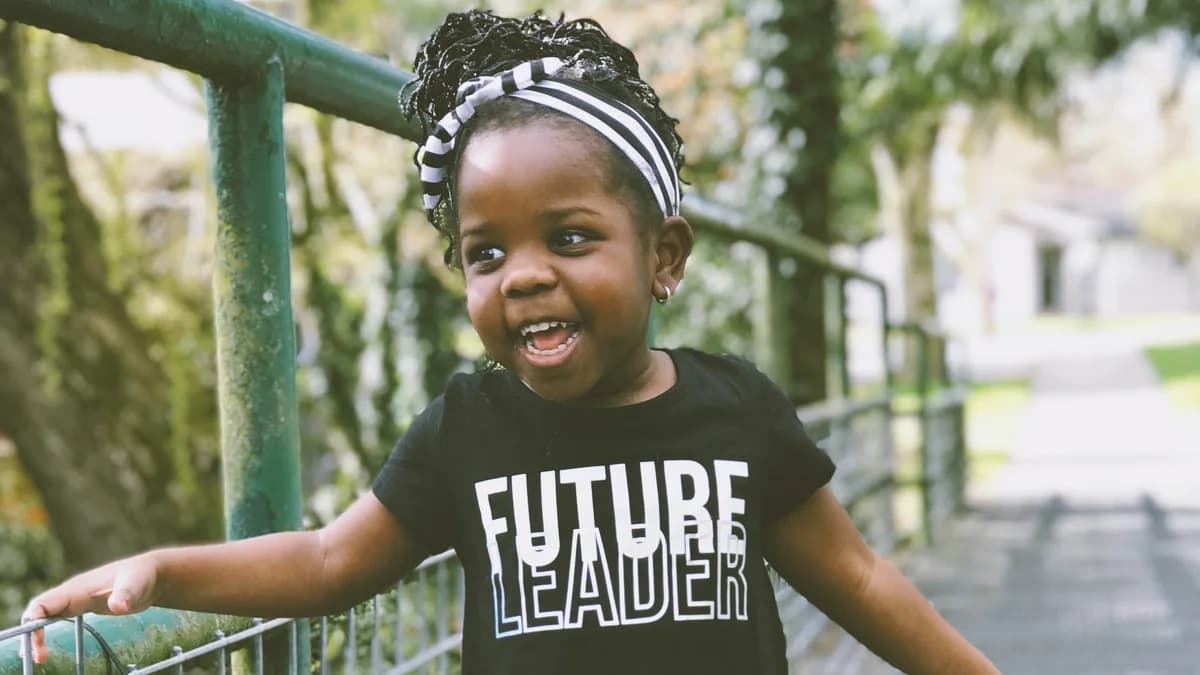 A young child wearing a Future Leader shirt