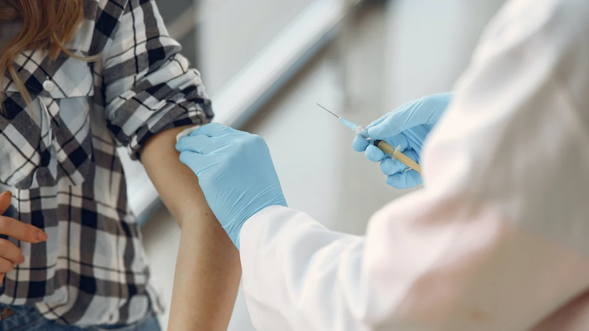 A health care professional administering a vaccine